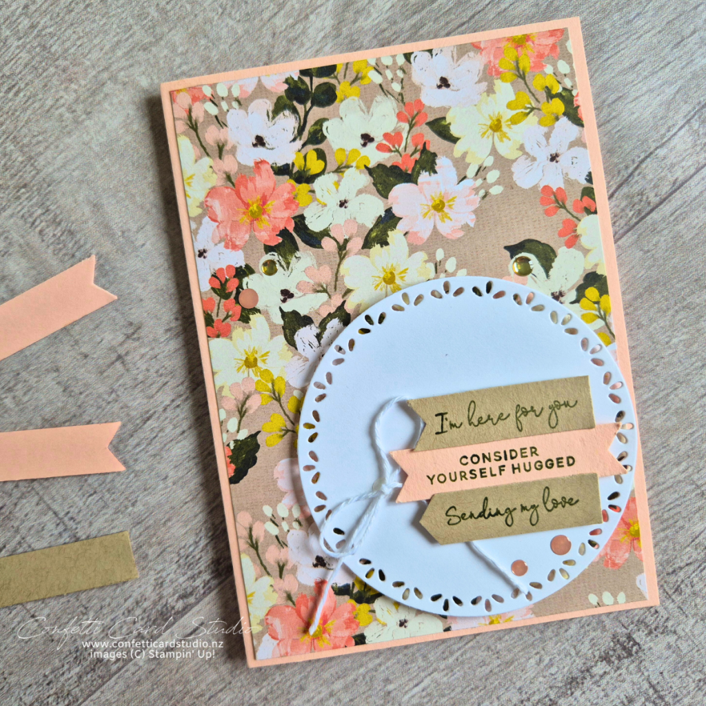 Floral card with circle focal point and 3 banners containing sentiments. Soft peach, apricot and kraft colours.