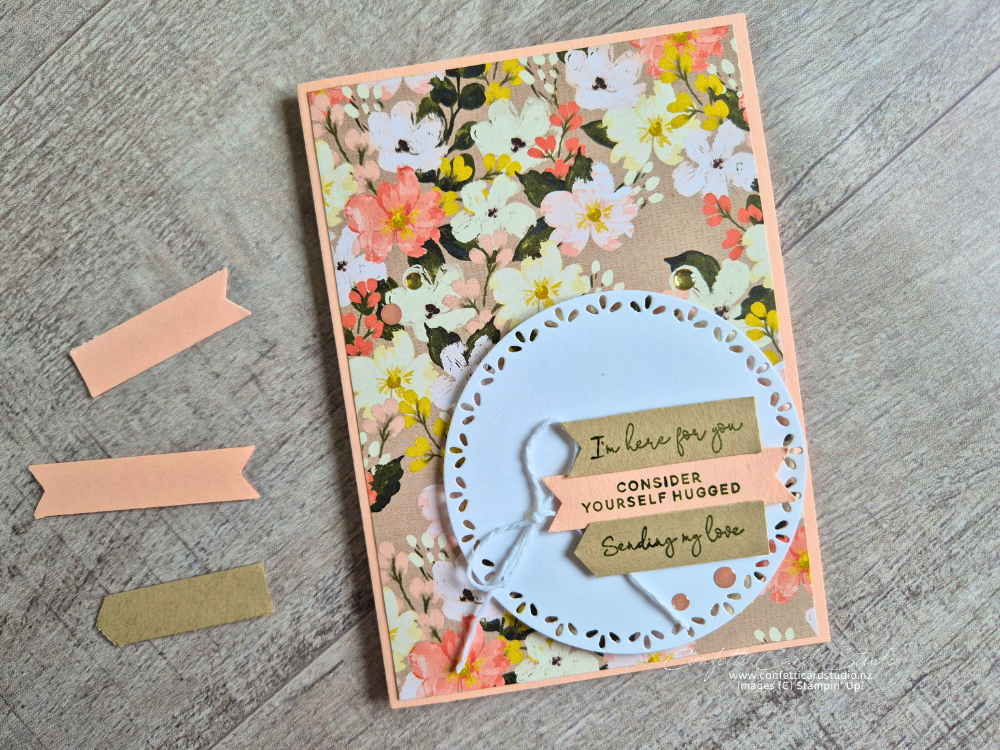 Floral card with circle focal point and 3 banners containing sentiments. Soft peach, apricot and kraft colours.