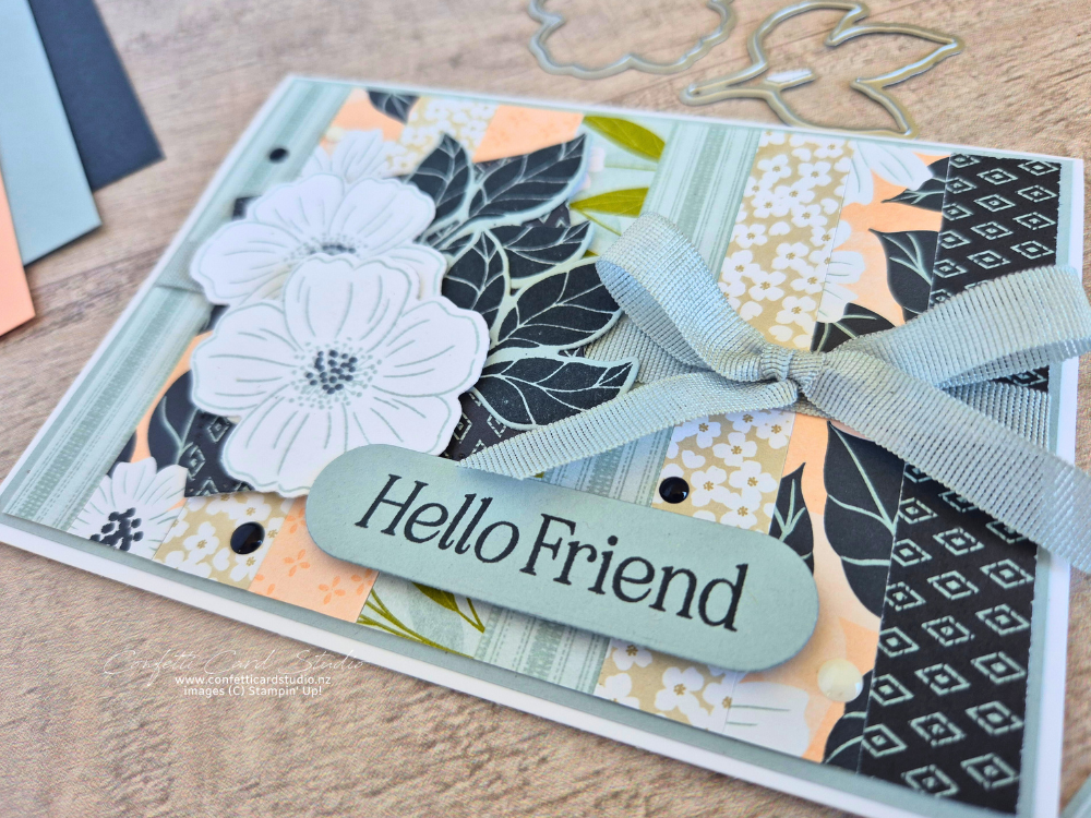 Handmade card using scraps of Lovely Blossoms DSP in cloud cover, secret sea and petal pink, featuring blossom flowers, leaves and a cloud cover ribbon bow.