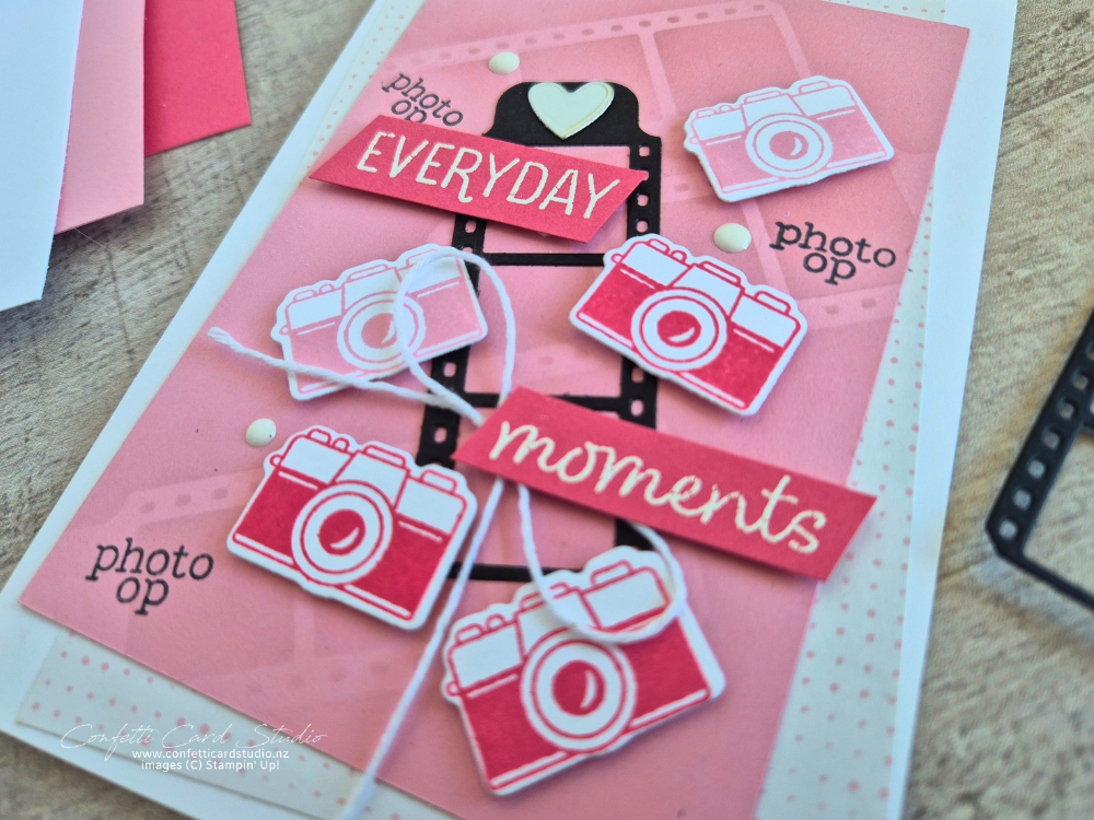 Handmade card featuring the Capturing Smiles Bundle with colourful camera die cuts, sponged film strip background, layered patterned paper, and memories theme.