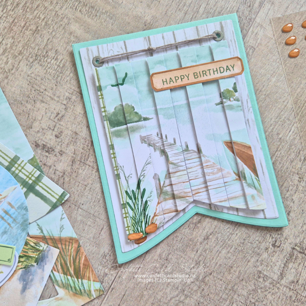 Double Vision Lakeside Retreat handmade card featuring a layered wharf scene with banner dies and a Pool Party card base using the double vision technique.