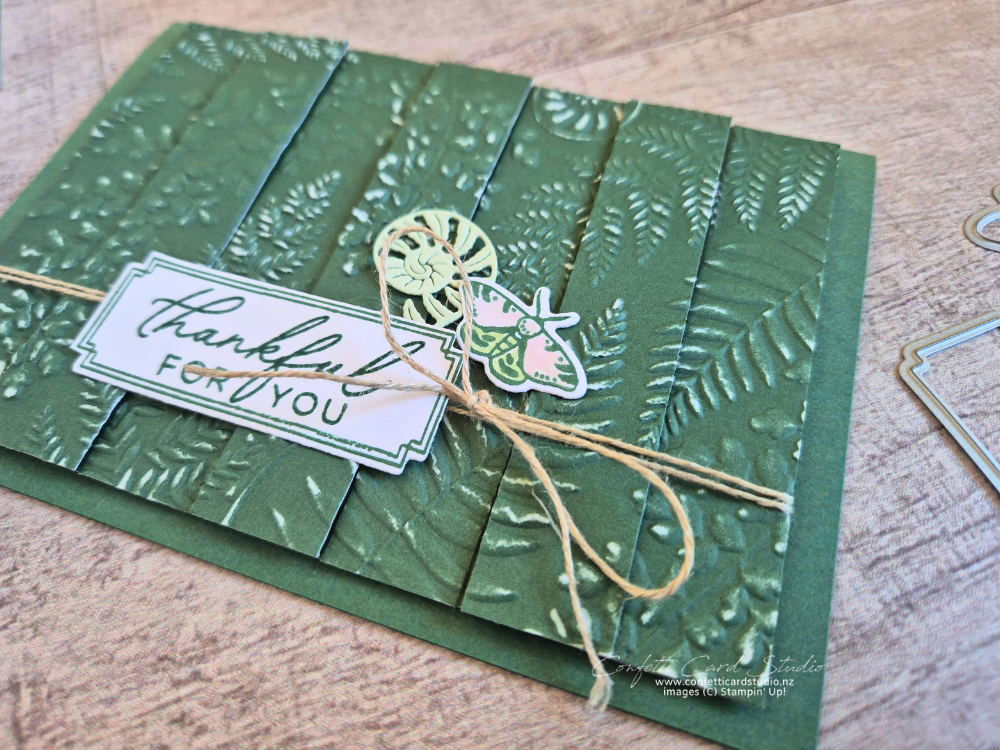 Handmade Fern & Flora Double Vision Card featuring embossed Peaceful Pine cardstock, layered fern strips, a moth embellishment, and textured botanical details.
