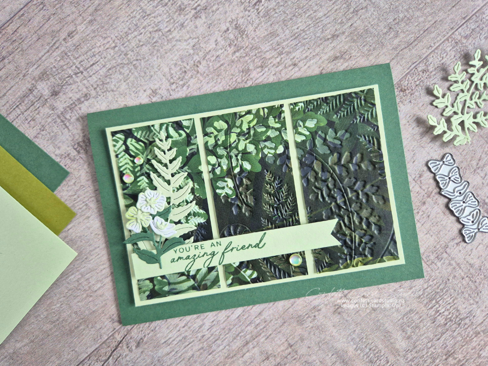 Handmade card featuring the Fern & Flora Embossing Ink Magic technique with embossed green foliage patterned paper, layered panels on Soft Sea Foam cardstock, floral embellishments, and a Peaceful Pine sentiment.