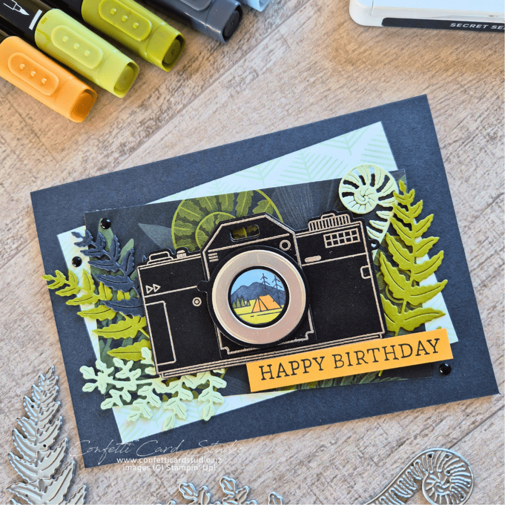 Handmade masculine camera birthday card with a black and silver camera, Moonlit Flora Designer Series Paper, camping scene, foliage, and Happy Birthday greeting.